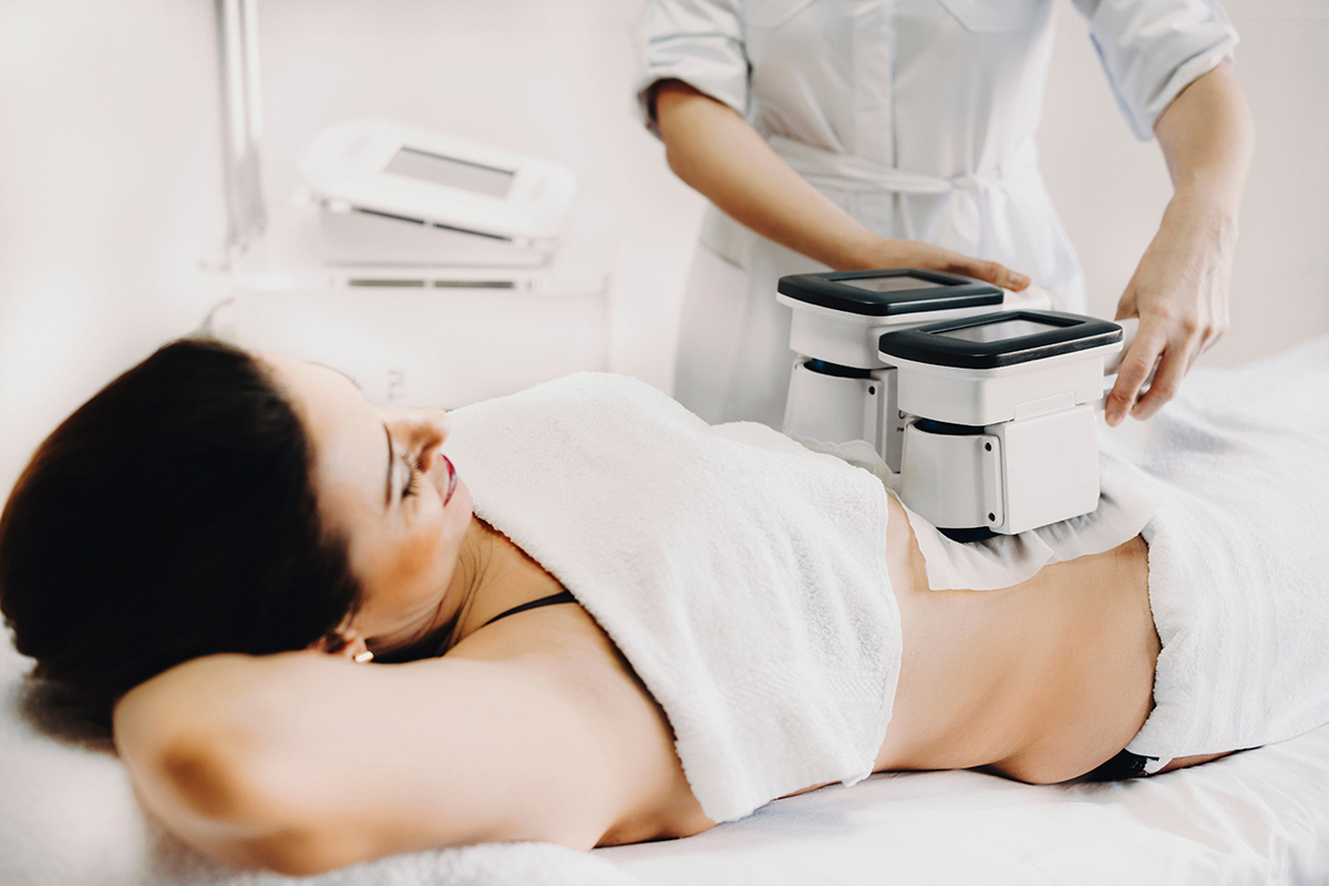 Adult woman doing cryolipolysis fat treatment procedure